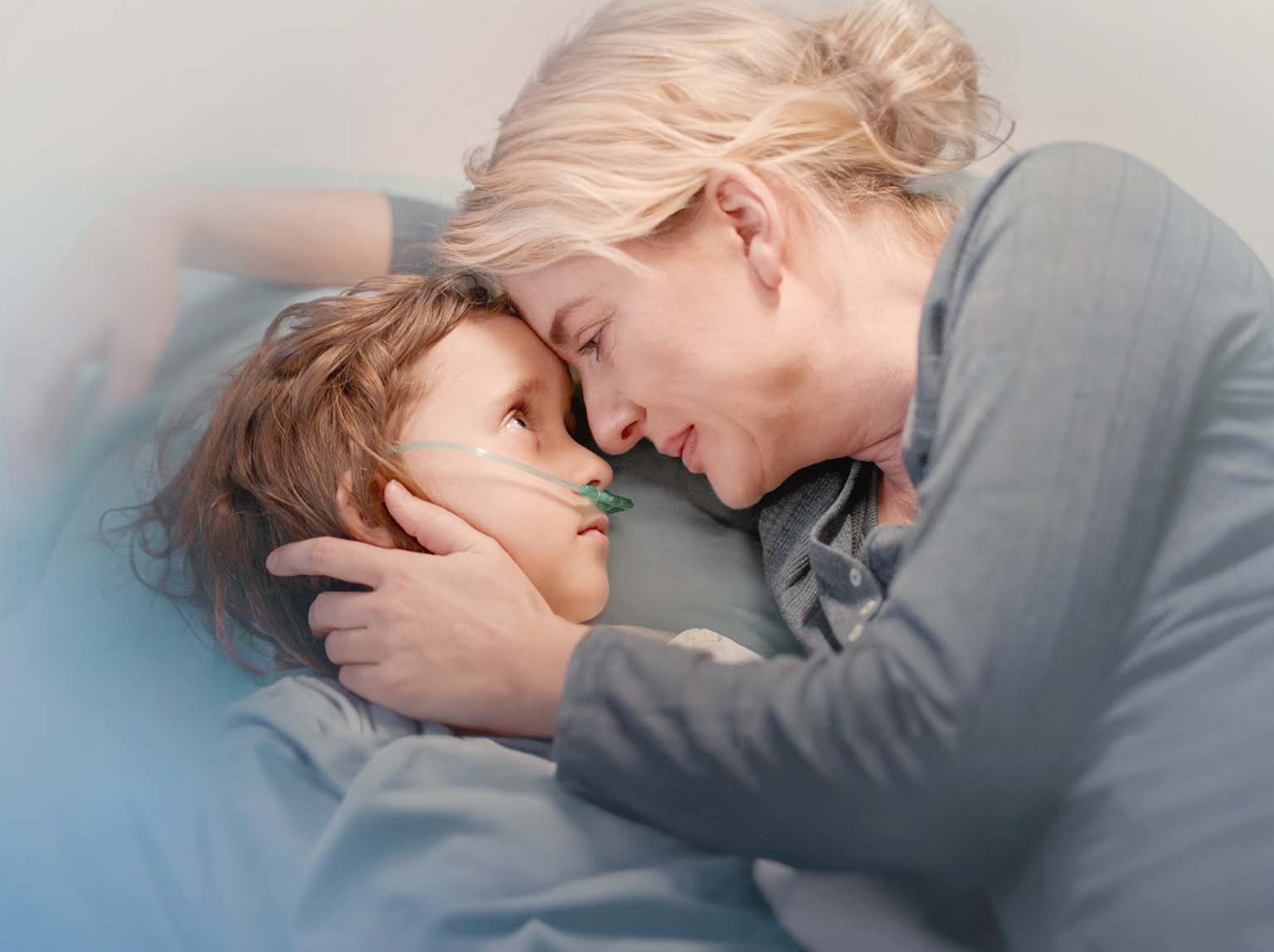 Photo of a mother holding her sick son